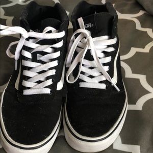 Black and white high top vans